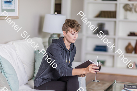 A young lady sitting on the couch stock photo with image ID: 328a5753-7c0f-4ec0-ab68-4d0ed8983267