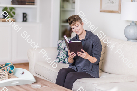 A young lady sitting on the couch stock photo with image ID: 32dfea31-0538-4fed-a017-c36496809d15
