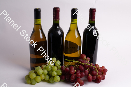 Four bottles of wine, with grapes stock photo with image ID: 35ef9c7c-9c89-4f55-912a-ffb2ea9014bc