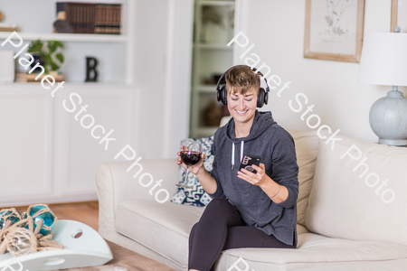 A young lady sitting on the couch stock photo with image ID: 377b33ea-2a0b-4021-bf52-4cd005825539