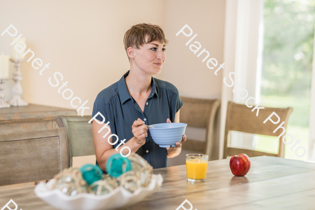 A young lady having a healthy breakfast stock photo with image ID: 3ad99bc7-b1de-4828-8367-3cd6f24487fe