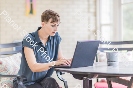 A young lady enjoying daylight at home stock photo with image ID: 3cc38213-8ad4-4ace-86f4-420e15c60407