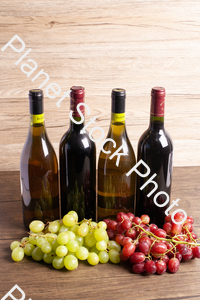 Four bottles of wine, with grapes stock photo with image ID: 3dcd047a-36f9-415a-94d4-ca0416da24ef