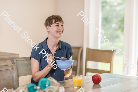 A young lady having a healthy breakfast stock photo with image ID: 409ff034-ab42-4412-ac58-247f09ddda66