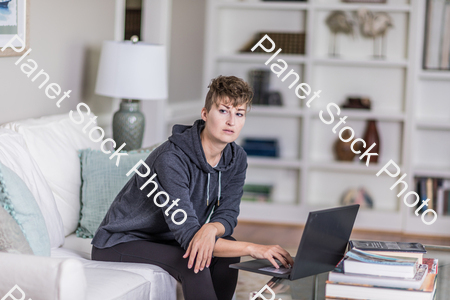 A young lady sitting on the couch stock photo with image ID: 4448811c-3703-4f94-a10c-b0283895bebe