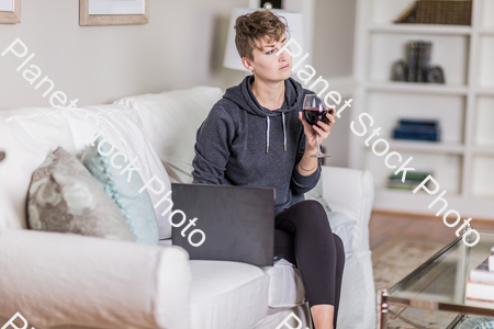 A young lady sitting on the couch stock photo with image ID: 460716bc-a184-4e15-b58c-e3b02c1f1c1b