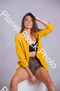 Model wearing yellow jacket, posing for a studio photoshoot stock photo with image ID: 4e6fae2d-0fa6-4117-9876-5980d857585d