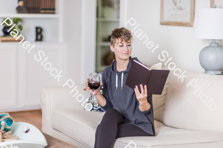 A young lady sitting on the couch stock photo with image ID: 51d79435-6982-48f1-a29d-3ddef2591fb6