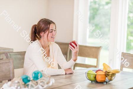 A young lady grabbing fruit stock photo with image ID: 51e37e1f-d54e-4606-af73-dde9e1e0397a
