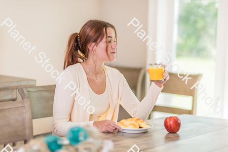A young lady having a healthy breakfast stock photo with image ID: 58a27bc4-14da-486f-bc64-3774456f622e
