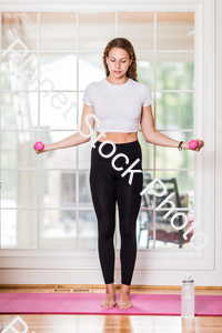 A young lady working out at home stock photo with image ID: 58c14da2-adf7-4c70-904f-a79892581e8e