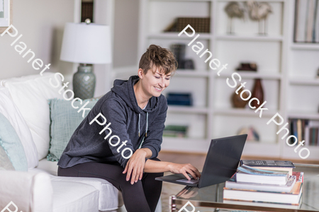 A young lady sitting on the couch stock photo with image ID: 590d7d53-4d7d-42b6-b998-19f04c1f7e74