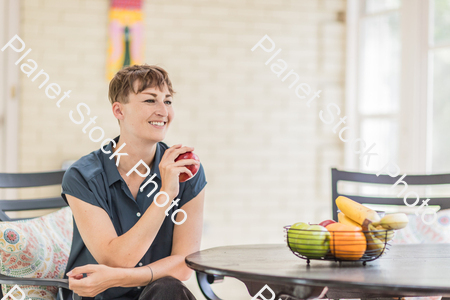 A young lady enjoying daylight at home stock photo with image ID: 596a5152-dffe-4609-9960-b3ba6a14a70d