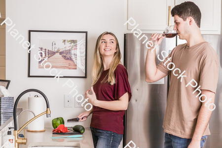 A young couple preparing a meal in the  kitchen stock photo with image ID: 5a2d0387-6260-41f6-a948-50848782cb1c