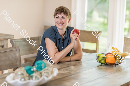 A young lady grabbing fruit stock photo with image ID: 5aeb9742-b23e-4fff-9f83-3567ee1d742d