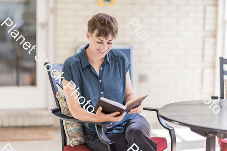 A young lady enjoying daylight at home stock photo with image ID: 5df83fdb-23de-467a-9f62-7f3d25a18c99