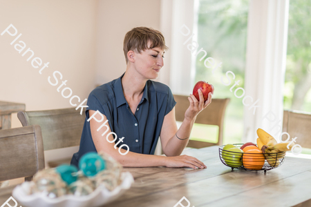 A young lady grabbing fruit stock photo with image ID: 653b54a2-c0c1-458f-af77-55ff3fcb1837