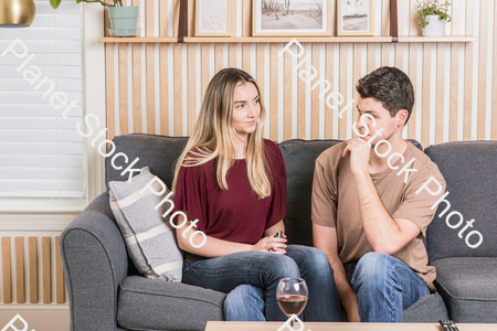 A young couple cozying up on the couch stock photo with image ID: 656385e2-02e4-4ac4-9ecc-2d1fcbb52e6a