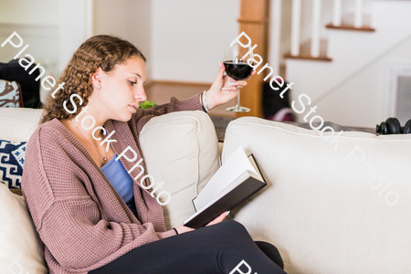 A young lady sitting on the couch stock photo with image ID: 6d4f57c7-db5c-418d-b8ed-082d7214bae9