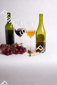 Two bottles of wine, with corkscrew, grapes, and wine glasses stock photo with image ID: 6e877a70-a24b-4d47-9d95-3f23a7388391