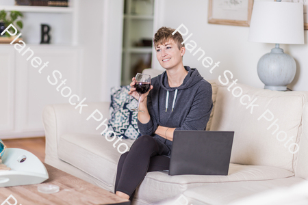 A young lady sitting on the couch stock photo with image ID: 70666380-4c70-4f37-bc3a-43044d209e5d