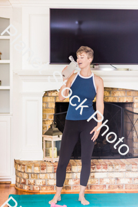 A young lady working out at home stock photo with image ID: 718d2140-0a5c-44a3-95fd-c4eb2b2bee79