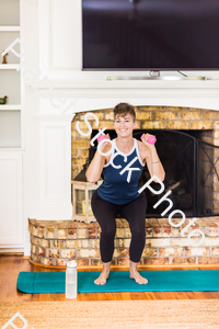 A young lady working out at home stock photo with image ID: 72194691-beca-4b40-8699-59a662fdf4a1
