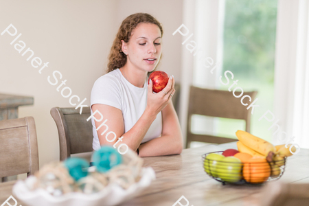 A young lady grabbing fruit stock photo with image ID: 7223ec18-fecf-498f-8914-ddd91db590a7