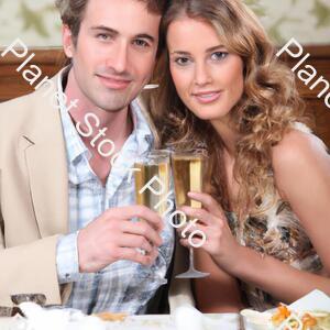 A Young Couple Enjoying Champagne at Dinner stock photo with image ID: 744258d5-2935-471a-a49b-85ed283ee958