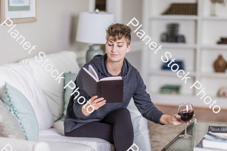 A young lady sitting on the couch stock photo with image ID: 784d8cf9-c01f-41c7-8270-b732f75359c9