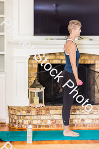 A young lady working out at home stock photo with image ID: 796cf7f5-9e41-436e-8bc2-5d32a4d59706