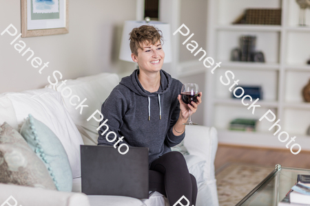 A young lady sitting on the couch stock photo with image ID: 7d394325-aab2-498b-9ec0-bbfed84e4481
