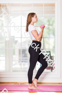 A young lady working out at home stock photo with image ID: 7db66a64-fba0-424f-93a9-da8cf841d450