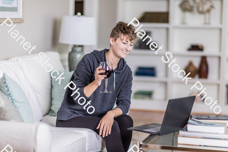 A young lady sitting on the couch stock photo with image ID: 7e09c64d-ded4-41d4-b310-df9fbeaf6d16