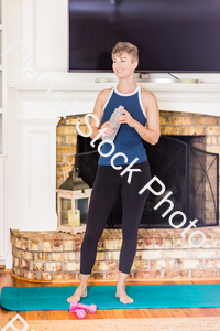 A young lady working out at home stock photo with image ID: 81dcf228-4fb8-429a-be3d-632224dcff06