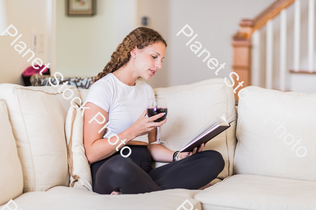 A young lady sitting on the couch stock photo with image ID: 87592133-c201-4ae9-be8f-bcf7e899c93a