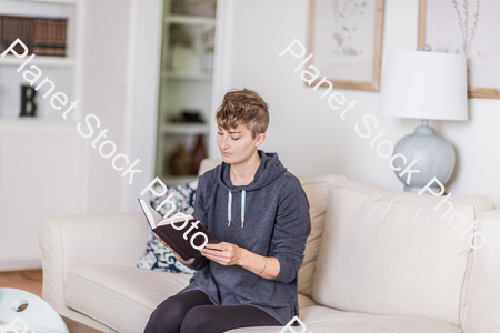 A young lady sitting on the couch stock photo with image ID: 87c21023-b225-4b85-b179-744b936c361f