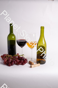 Two bottles of wine, with corkscrew, grapes, and wine glasses stock photo with image ID: 88e06fbb-849d-446c-a742-c57554dcb062