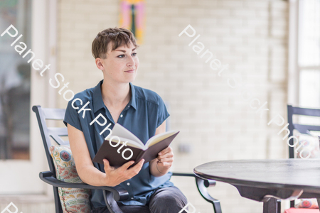 A young lady enjoying daylight at home stock photo with image ID: 8ed71846-4f7e-4fc8-81a0-fc94f249e069