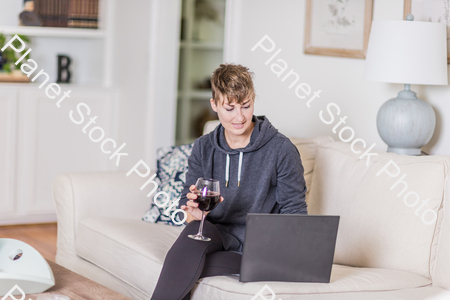 A young lady sitting on the couch stock photo with image ID: 91050085-4f25-452d-bf0f-a1c4029013f8