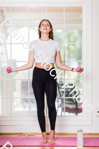 A young lady working out at home stock photo with image ID: 911e14a0-7d8f-48e9-9d14-f0e64f7e2031