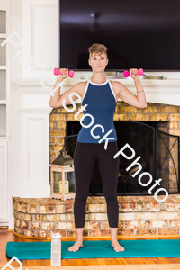 A young lady working out at home stock photo with image ID: 91bf1a68-01a3-4b88-9733-5b5244d85233