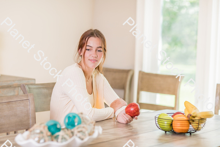 A young lady grabbing fruit stock photo with image ID: 940e1bb8-a4b1-424b-8d37-8dc8c7fccdbb