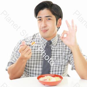 A Man Eating Food stock photo with image ID: 9463889a-0757-47a0-8e0f-6a31a6379a83