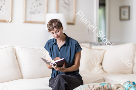 A young lady sitting on the couch stock photo with image ID: 94cbefaa-2333-4ce1-a71e-6df39f5710dc