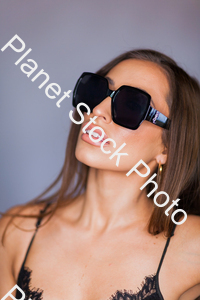 Face shot of a model in black outfit in a studio photoshoot stock photo with image ID: 9f83238a-9356-4d36-9c93-9b372141f4cf