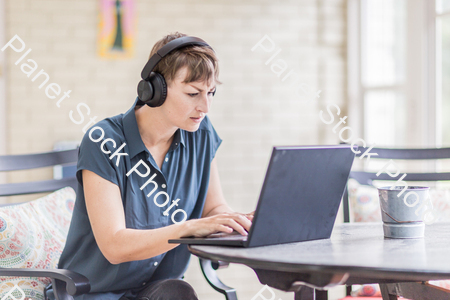 A young lady enjoying daylight at home stock photo with image ID: a522b13f-385b-4391-b140-909b0d411ac7