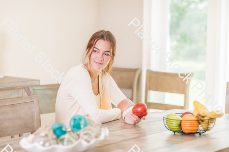 A young lady grabbing fruit stock photo with image ID: a6942b7c-2895-48ae-ae3e-a71baf936701
