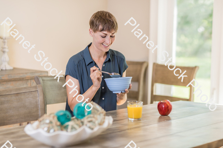 A young lady having a healthy breakfast stock photo with image ID: a8369550-ab19-4b8c-9850-026ea9c169e9