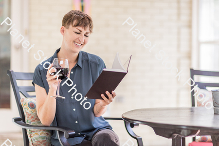 A young lady enjoying daylight at home stock photo with image ID: a8b7dabe-f49f-48c6-b3cd-ea0f86c1703f